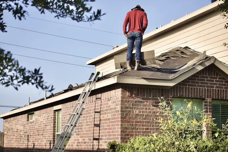 Professional roofer working on a residential roof in Hackensack